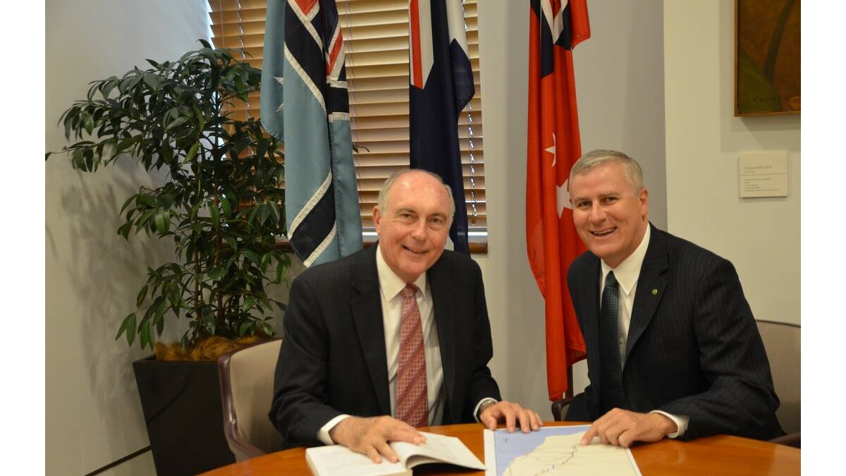 NATIONALS leader Warren Truss (left) and Member for Riverina Michael McCormack discuss the Roads to Recovery program.