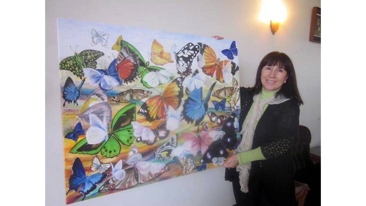 CARMELA Kozlowski with one of her artworks that is currently featuring at the Historic Hydro Motor Inn art space.