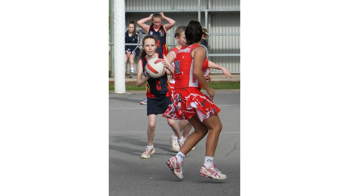 NAOMI Wyles looks for a teammate in under 13s netball.