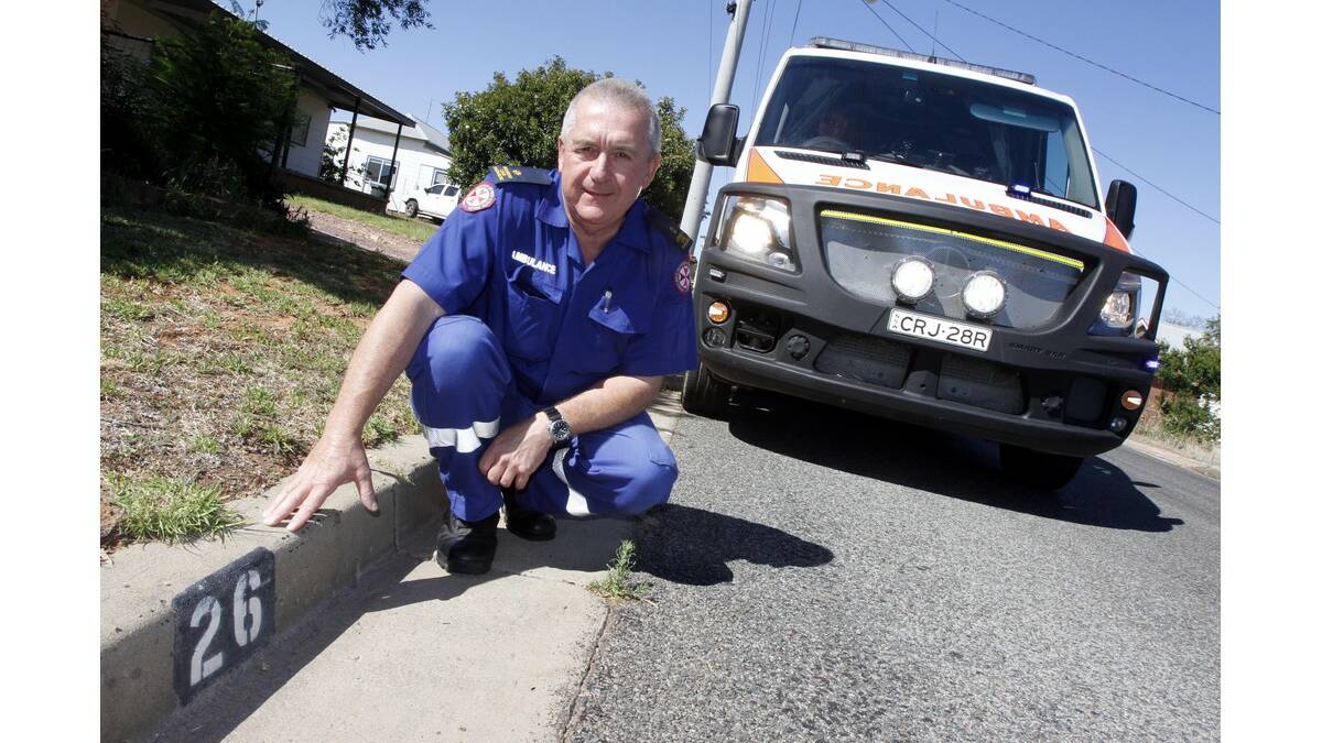 LEETON chief paramedic Chris Bailey points out a useful example of a residential numbering system, painted on gutters outside homes.