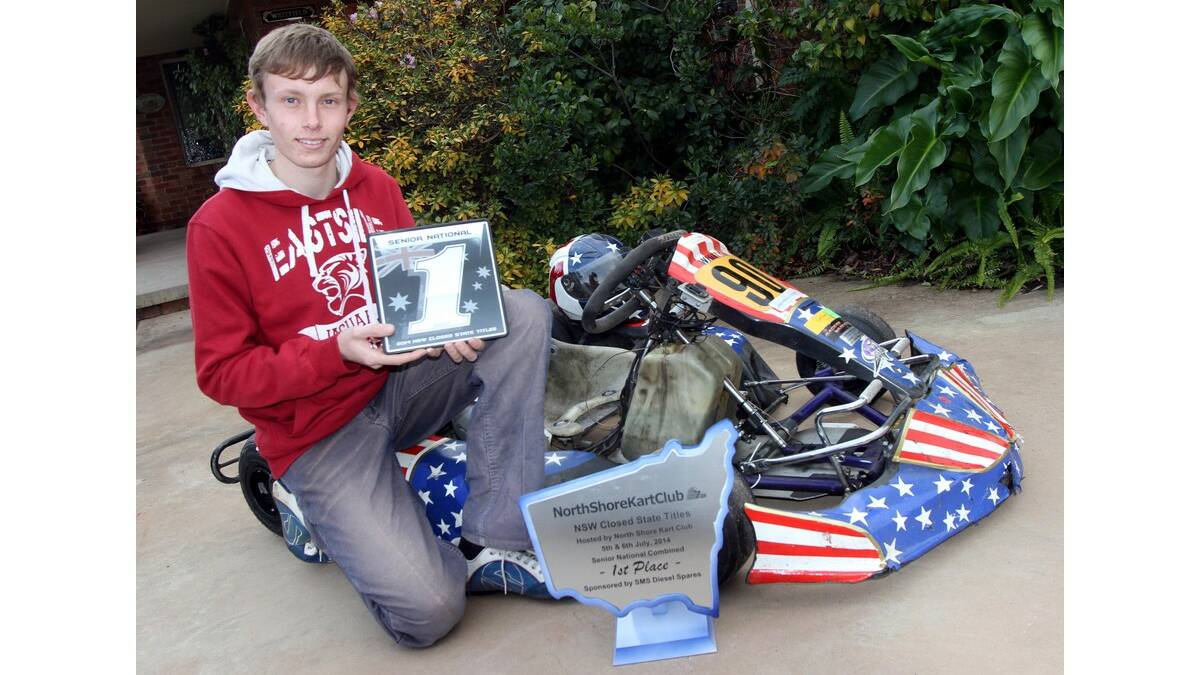 JARROD Whitty, 16, shows off his number-one plaque and trophy as the senior national class winner at the 2014 NSW Closed State Titles. 