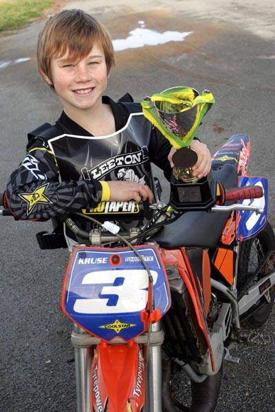 LEETON rider Kruse Brady, 9, with his trophy and medal for finishing third at the Australian Junior Dirt Track Championships in the seven to under nine years, 65cc class.