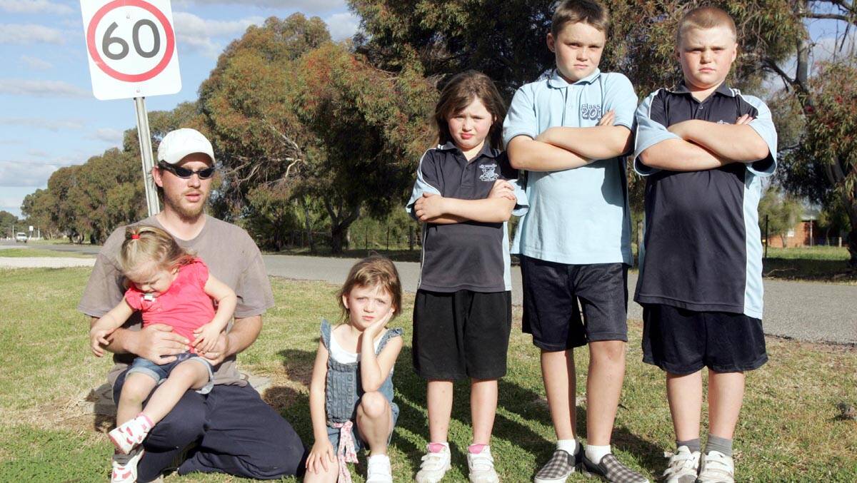 THE family of accident victim Nikea Coram, 13, including (from left) step-father Brendan Stanton, holding Shaila Stanton, 2, Jaylee Stanton, 4, Brydee Stanton, 6, Ben Morrow, 11, Kye Stanton, 9, is pleading for motorists to slow down on Lillypilly Road.