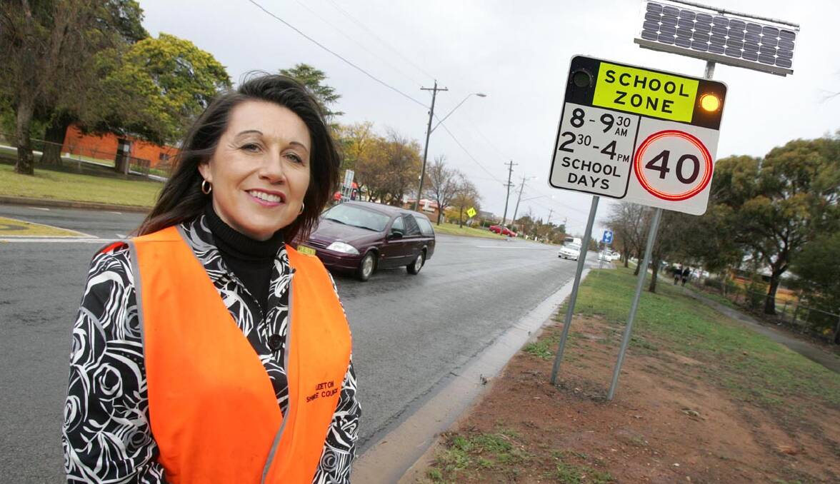 LEETON Shire Council road safety and traffic officer Sandra Robinson shows what the flashing school zone lights to be installed outside Leeton Public School in Wade Avenue will look like. This photo has been digitally altered.