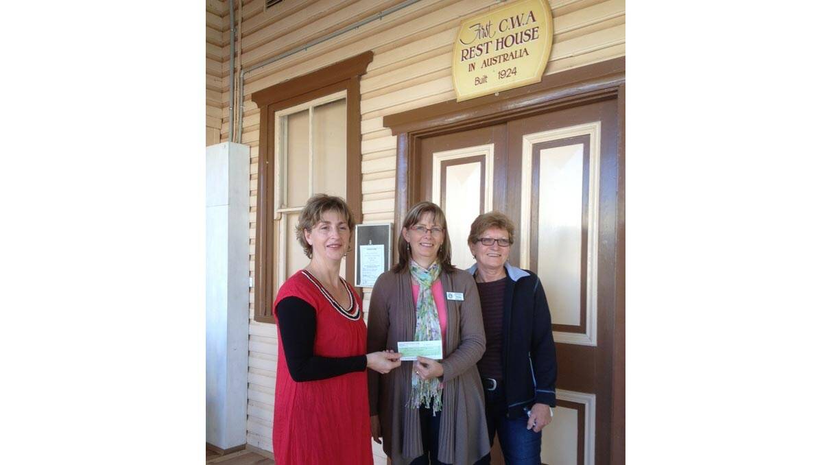 BARELLAN Masters Games president Jodie Landy (left) presents a donation to Barellan CWA president Donna Robertson and committee member Heather White.