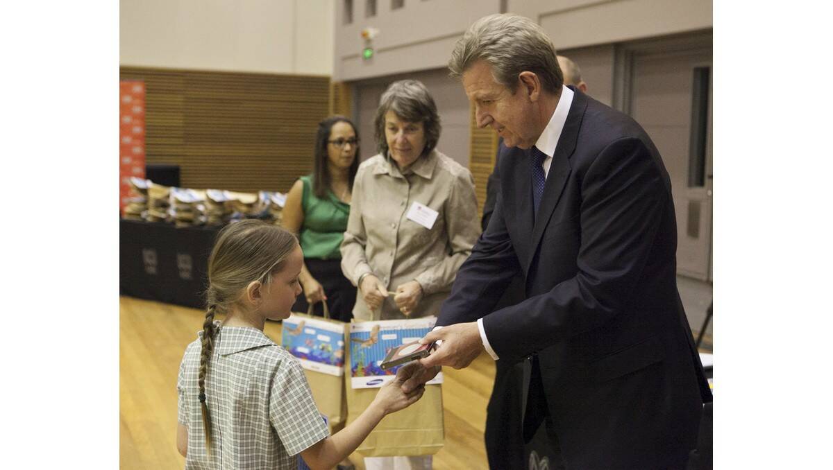 PARKVIEW Public student Lilly Davies receives a medal from NSW Premier Barry O'Farrell at the state final of the Premier's Spelling Bee.