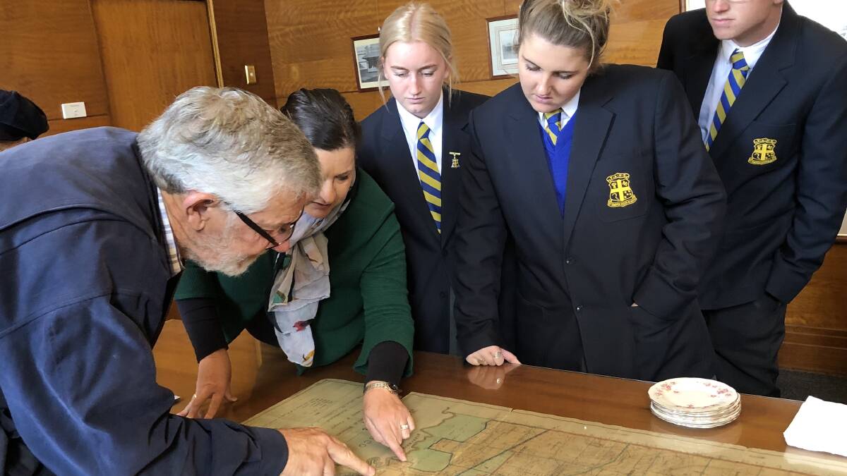 AN INVALUABLE FIND: Leeton Shire Mayor Paul Maytom looks at the map with Teacher Rebecca Ormond and her students from Yanco Agricultural High School; Mitchell Whyte, Eliza Kurrle and Isabella Whitehead. PHOTO: Contributed 