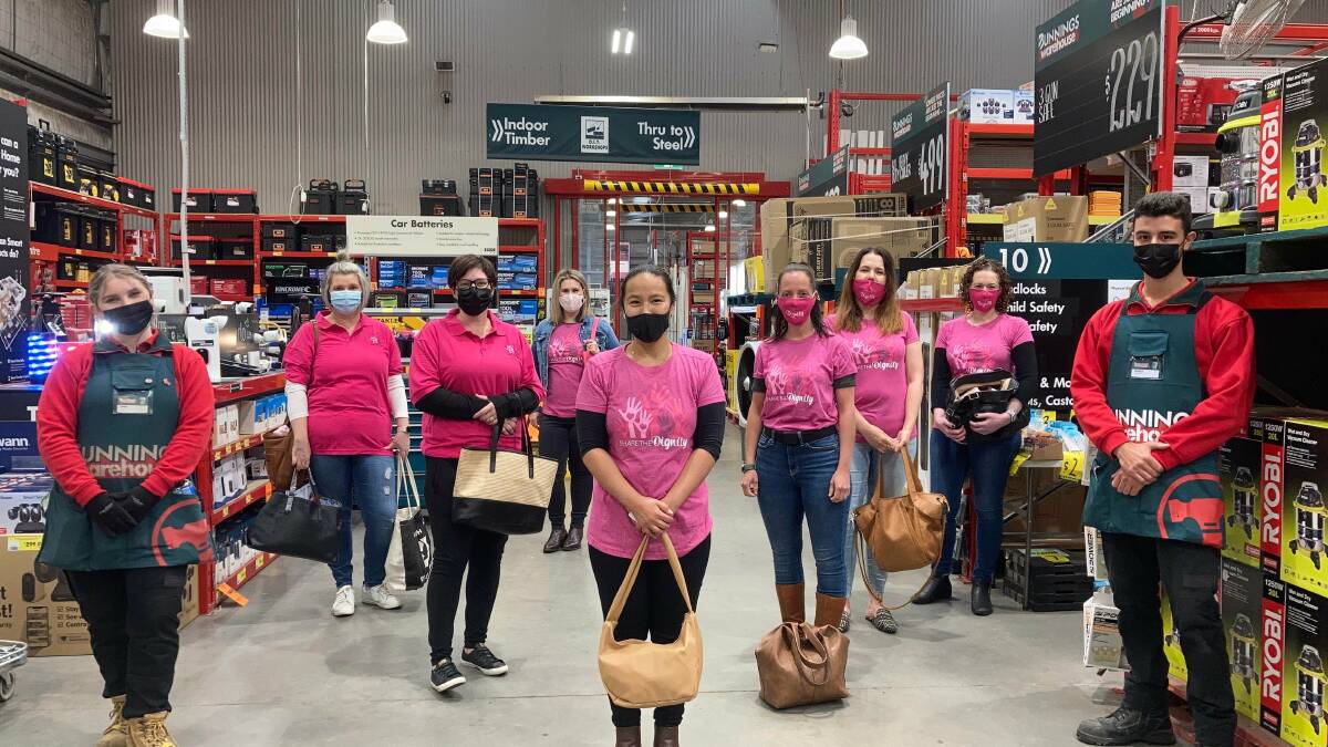 IT'S IN THE BAG: Share the Dignity volunteers for Griffith and Leeton pose alongside Bunnings staff members with bags filled with essential items ready for donation to those in need. PHOTO: Contributed