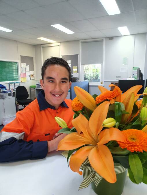 DRESSED FOR A CAUSE: Leeton Public School student Tobias Kelly lives with Prader-Willi Syndrome and wore orange to raise awareness of the syndrome at Leeton Public's mufti day. The orange flowers pictured have been donated by Arbour and Ivy Flowers. PHOTO: Maria Punturiero