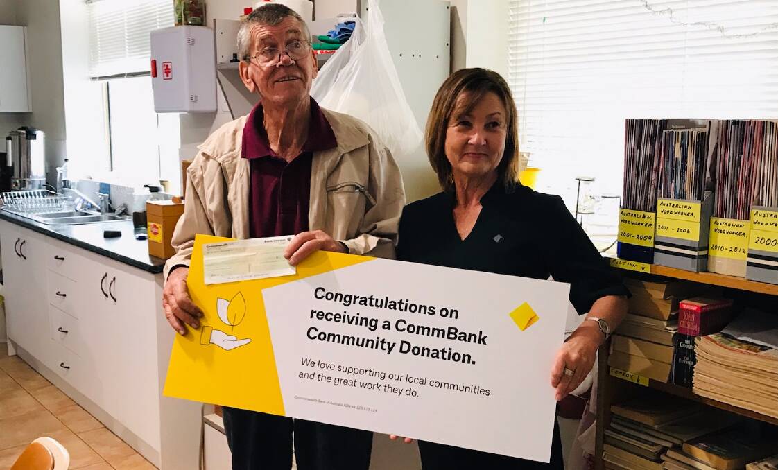 ALL SMILES: George Reynolds (L) and Karen Eckly (R) pose with community donation. PHOTO: Commonwealth Bank Leeton