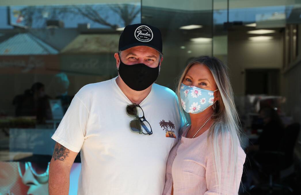 Glenn and Karen Pallister were masked-up on Saturday morning while lining up for a store. Picture: Emma Hillier
