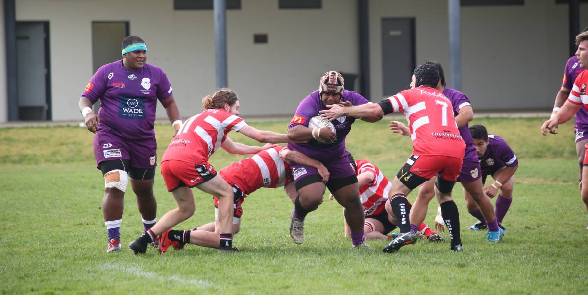 FULL SPEED AHEAD: Leeton Mighty Phantom's Koresi Waqanivalu fends off all-comers at the home match against CSU Reddies at Leeton's Number 2 Oval over the weekend. PHOTO: Anthony Stipo