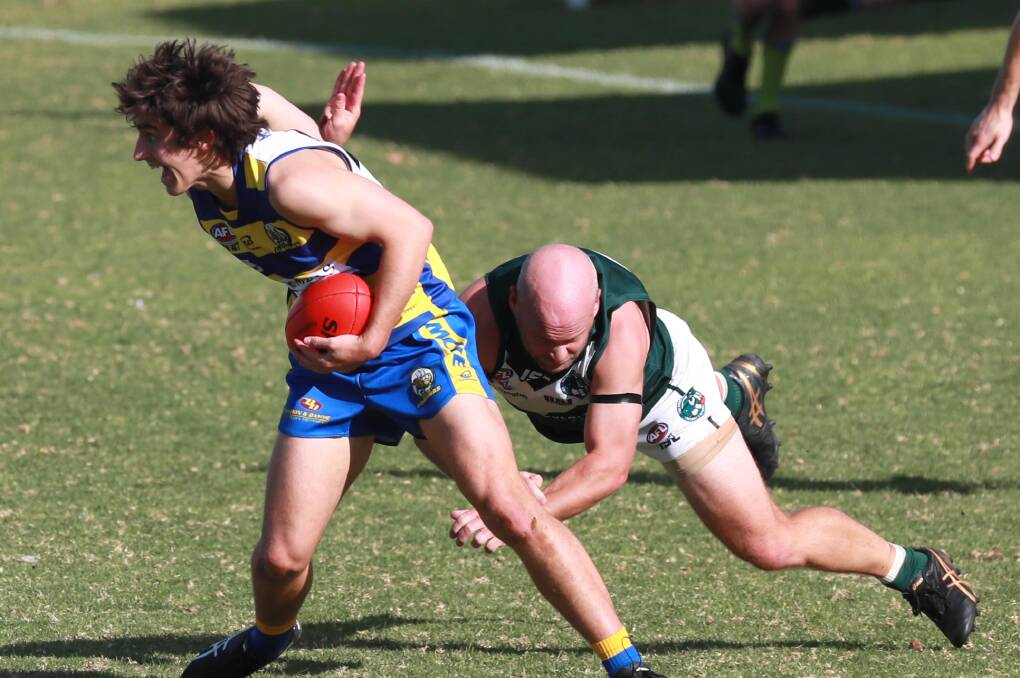 TOUGH SLOG: Coolamon's Jamie Maddox tackles an MCUE opponent last week. Picture: Les Smith