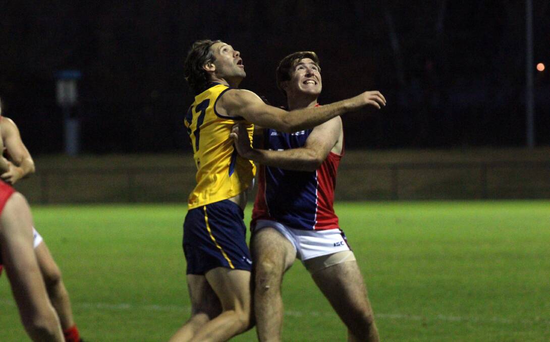 EYE ON THE BALL: Riverina's Ben Walsh and Canberra's James McCabe compete in the interleague game at Football Park in Canberra on Saturday night. Picture: Matt Olsen
