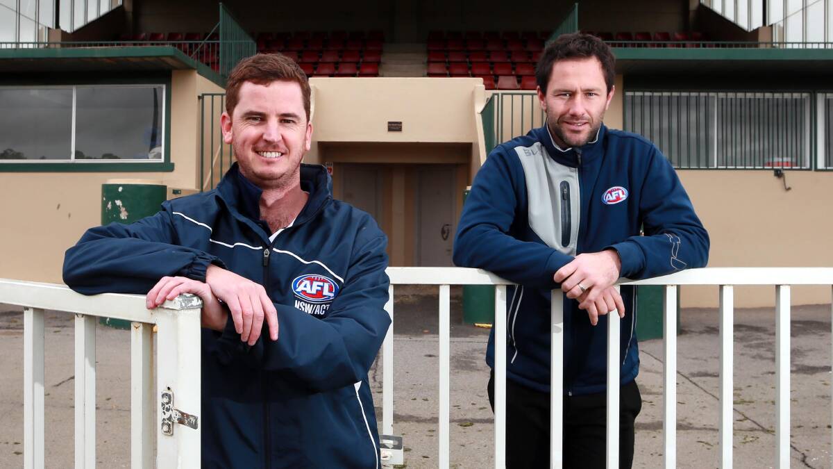 BRING IT ON: AFL Southern NSW staff members Tom Walker and Marc Geppert at Robertson Oval on Thursday. Picture: Les Smith