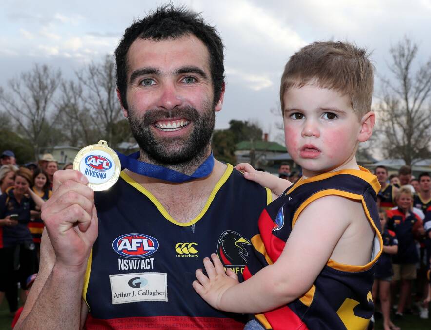 Bryce O'Garey, with son Boston, after being named best-on-ground in Leeton-Whitton's grand final win.