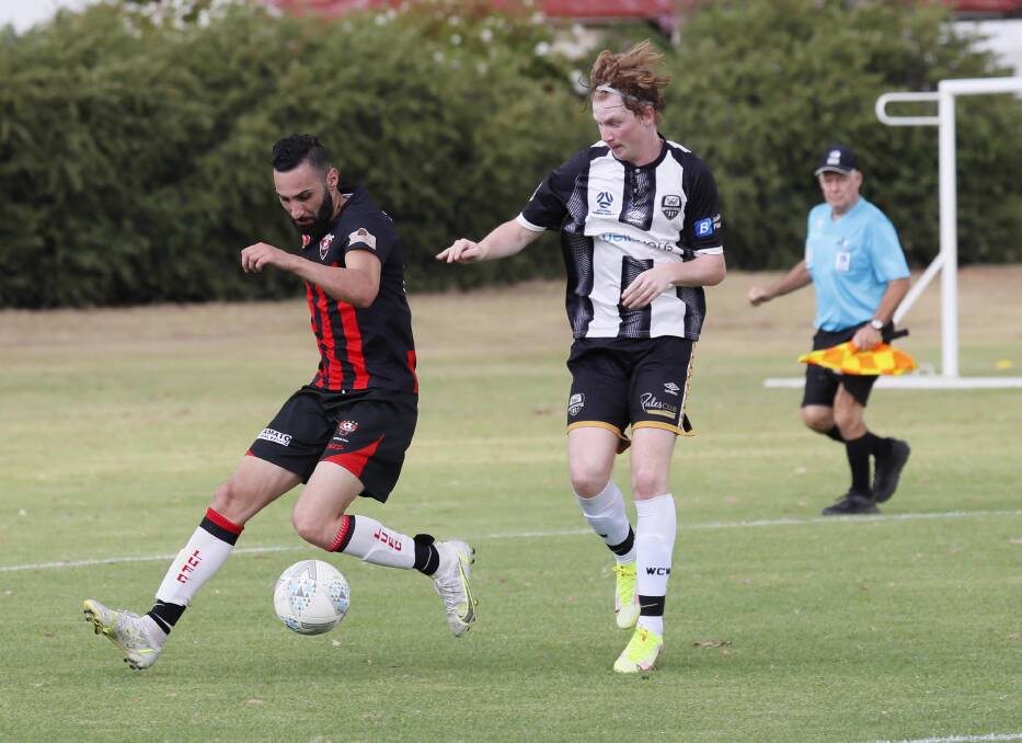 Leeton United's Fred Gardner competes against Wagga City Wanderers' Josh Nesbitt in a pre-season trial match earlier this year at Gissing Oval. Picture by Les Smith