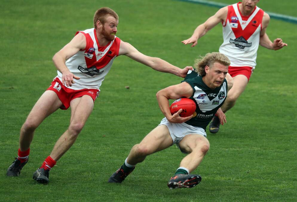 Coolamon's Jerry Maslin looks to escape Griffith's James Taylor at Narrandera Sportsground last September. Picture: Les Smith