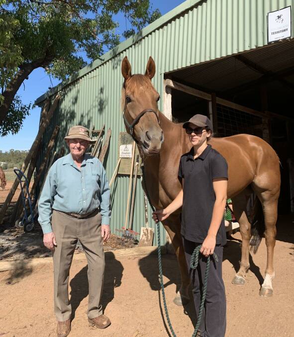 SPECIAL MOMENT: Picnic rider Bree Pitt with Bye Bye Benji and Leeton trainer Peter Clancy at his stables on Friday.