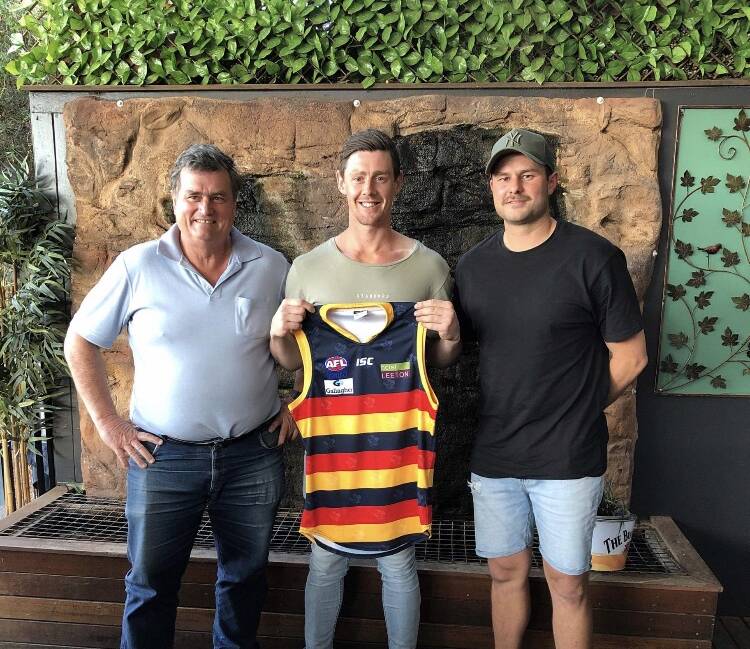 NEW COLOURS: Leeton-Whitton official Tim Carroll (left) and coach Daniel Muir (right) welcome former AFL player Sam Darley to the Crows.