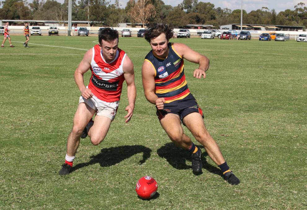 HARD BALL GET: Collingullie's Jimmy Kennedy and Leeton-Whitton's Ben Gaynor go at it at Leeton Showground on Saturday. Picture: Anthony Stipo