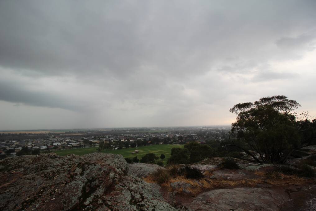 The view of Griffith covered in dark clouds, as seen from Scenic Hill on Sunday. PHOTO: Jacinta Dickins