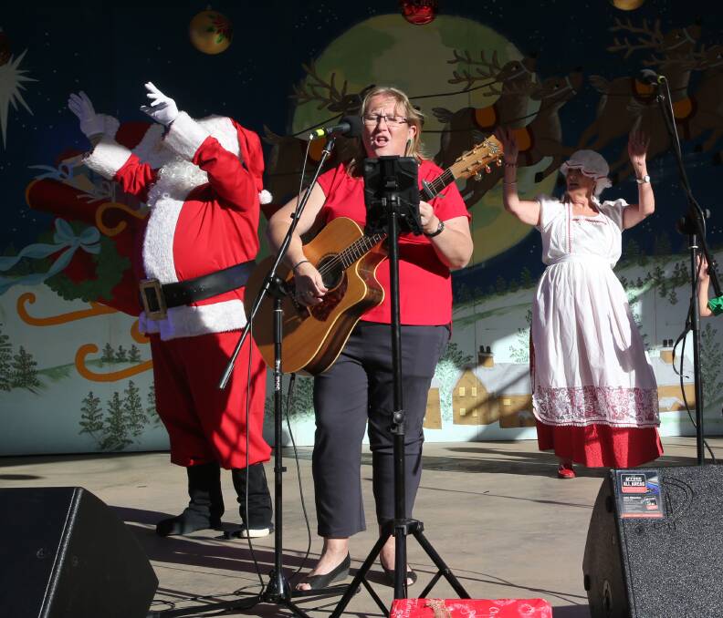 GET JOLLY: Rebecca Van den Heuvel performs to welcome Santa and Mrs Claus to the stage to kick off the 2018 community Christmas concert.