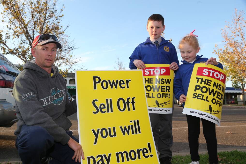 2014: Andrew Sidebottom, with his children Campbell, 9, and Matilda, 6, were among many that rallied outside member for Murrumbidgee Adrian Piccolis office on Thursday afternoon to protest the privatisation of electricity poles and wires.