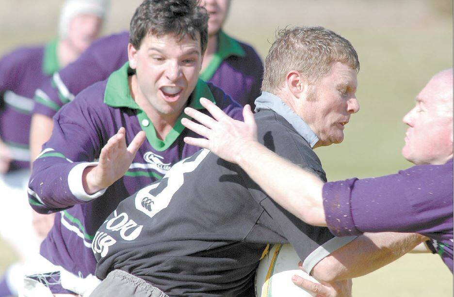 2004: Loose forward Stuart Stout has eyes only for his Griffith opponent while helping out teammate Steve Walkerden (right) in a tackle on Saturday.