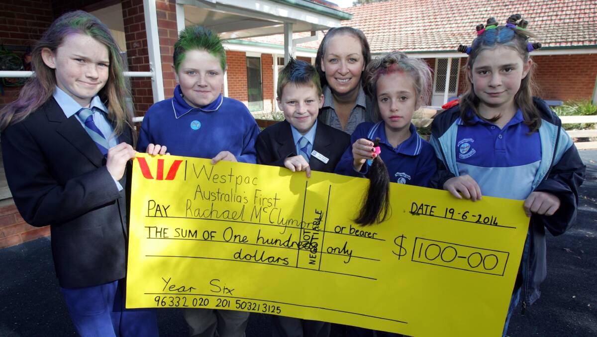 2014: Yanco Public School teacher Rachael McClymont half of her head shaved at YPS with the other part completed at Narrandera East Public School. Year 6 leadership group members (from left) Sharna Spicer, Josh Miners, Kyle Zylstra, Talee Warren and Elliane Boulton helped to raise $100 for the World's Greatest Shave cause for the final tally.