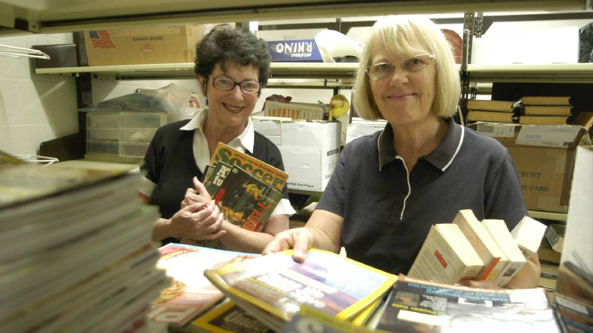2009: Sorting out some of the publications for the book sale are Friends of the Library secretary Marg Barnett (left) and chairwoman Sue Ireland.