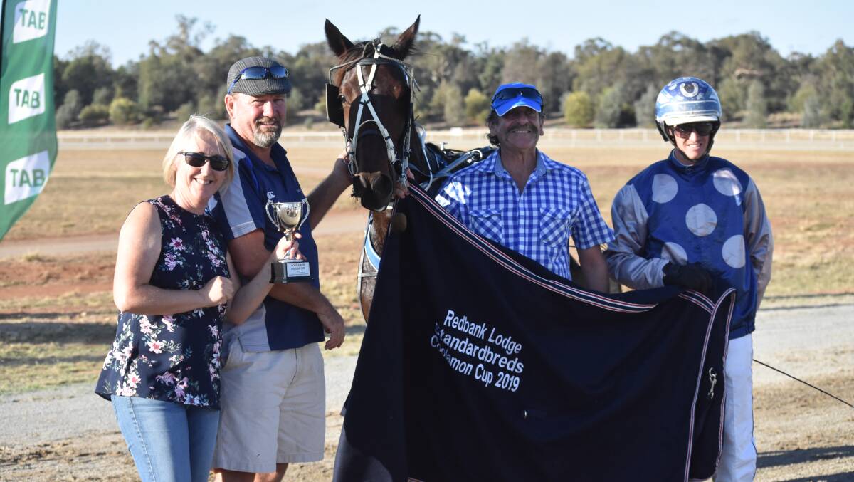 Kylie and David Kennedy collect the Coolamon Pacers Cup off sponsor Paul Kahlefeldt after Jive Dancing and Blake Jones' impressive win.