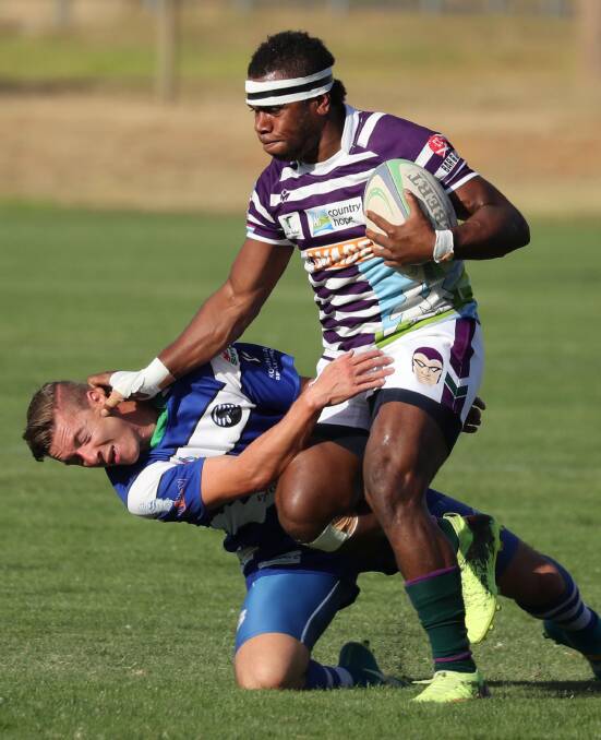 GET OUT OF MY WAY: Petero Taitusi gives John Sutcliffe a big fend off during Leeton's big win over Wagga City at Conolly Rugby Complex on Saturday. Picture: Les Smith