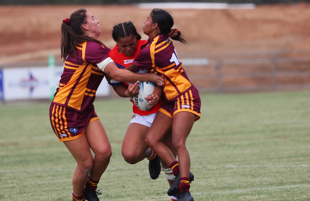 Anistacia Shum gets stopped by two Riverina defenders on Saturday.