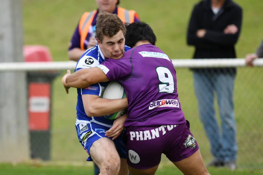 CRUNCH: Nathan Smith gets met by a strong tackle from Wah Paw in Wagga City's win over Leeton at Conolly Rugby Complex on Saturday. Smith scored a hat-trick.