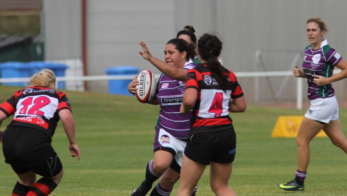 DODGING DEFENDERS: Dianas' vice captain Amie Fazekas tries to avoid the oncoming Tumut defence.