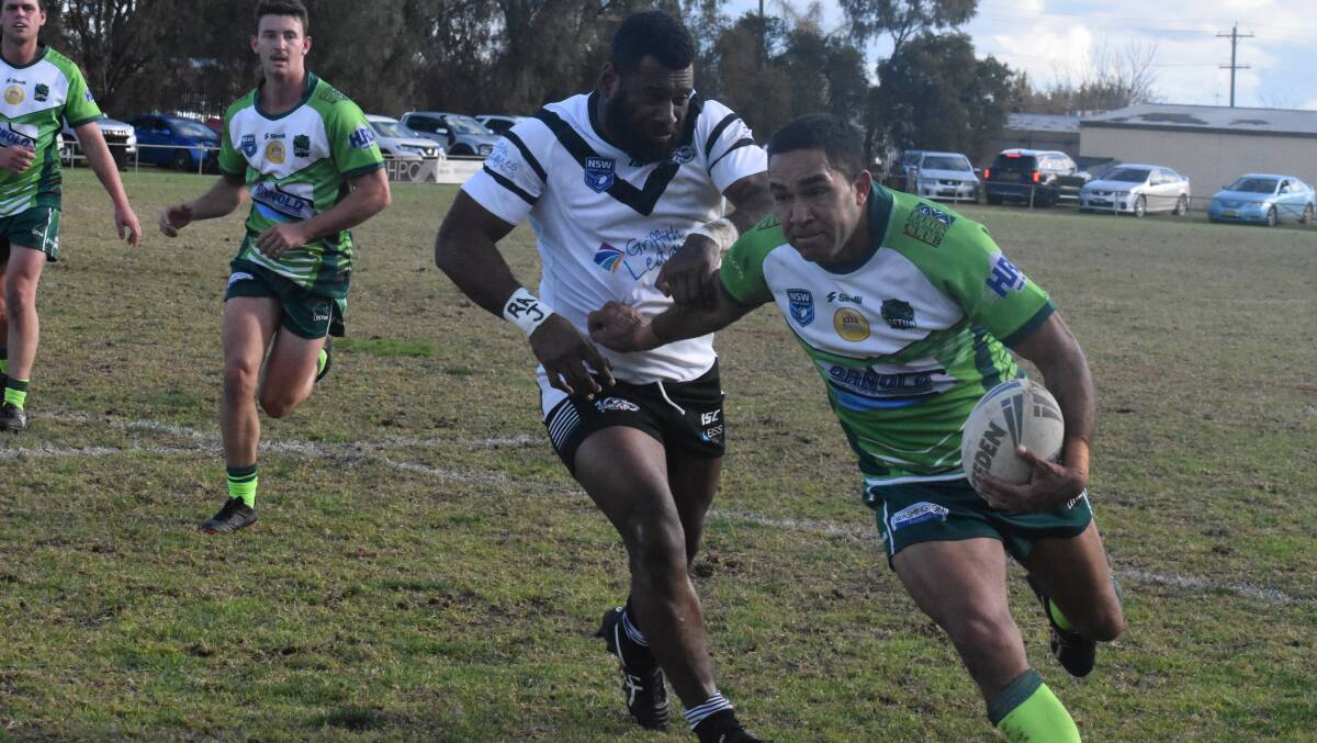 PUSHING AWAY: Greens' George Broome tries to brush aside Black and Whites' Tomasi Caqusau during Leeton's loss on Sunday. PHOTO: Liam Warren