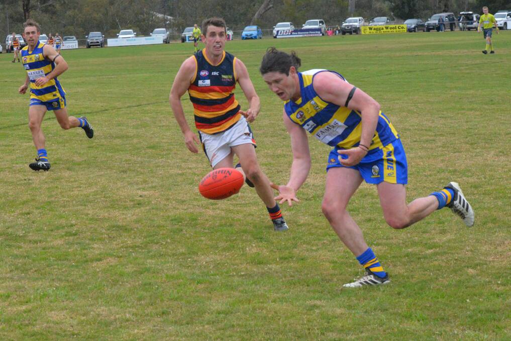 CLOSING IN: Crows' Tom Meline looks to put pressure on Mangoplah's Matt Collins during their clash on Saturday.