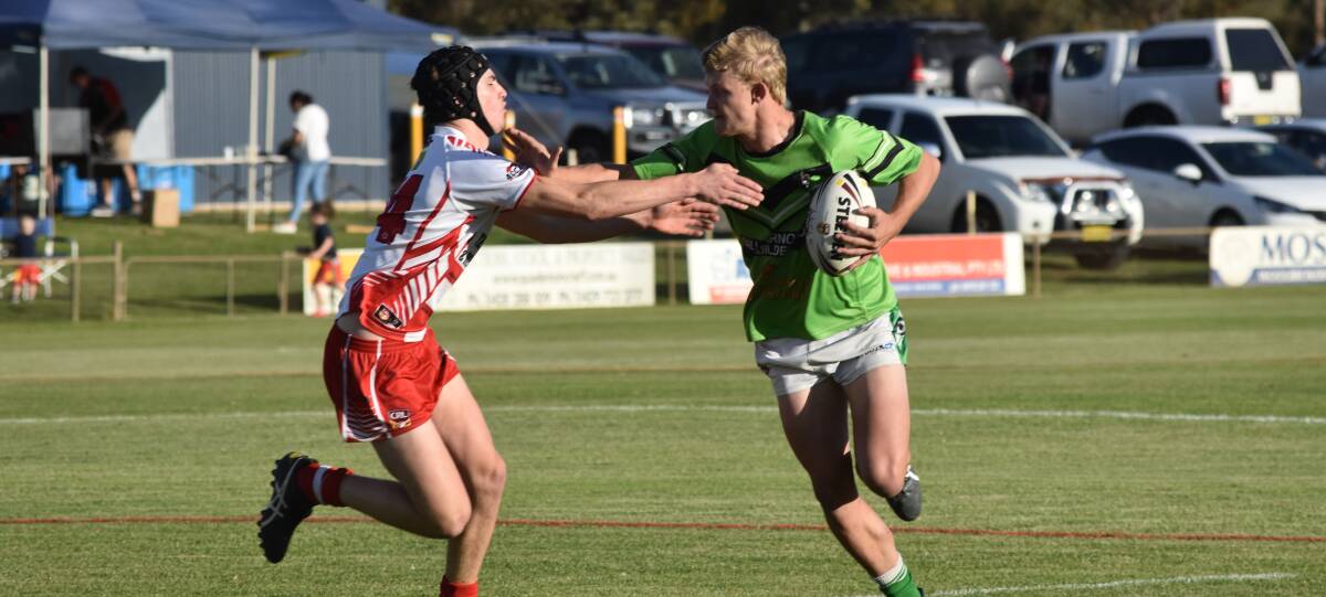 STRONG ARM: Leeton centre Josh Fisher tries to fend off Temora counterpart Tyler Madden as the Dragons started the West Wyalong Knockout on a winning note on Friday. Picture: Courtney Rees