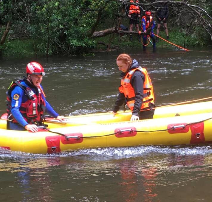 One of the stranded Sydney scouts is taken to safety onboard the Ulladulla SES Unit's Angel Arc inflatable rescue craft by flood rescue team members Bill Frazer and Gary Smith. Image: Ulladulla SES
