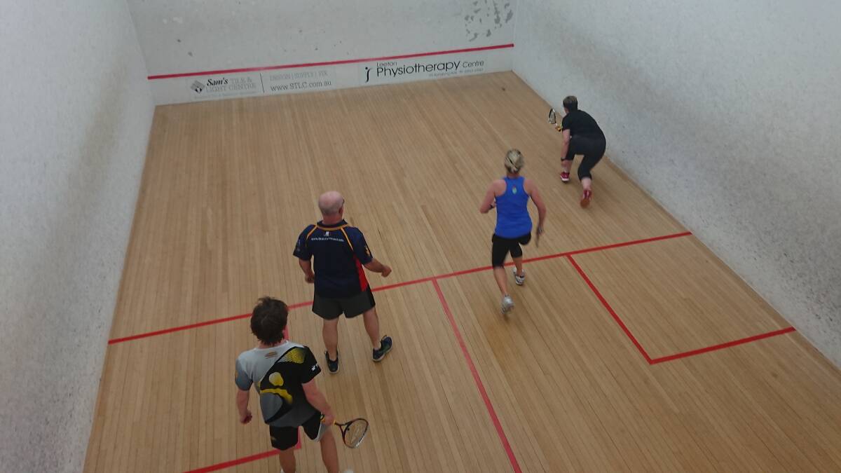 Declan Ryan at rear of court, Miranda Tait hitting the ball, and Marcelle Steele and Gary Thompson at the centre of the court.