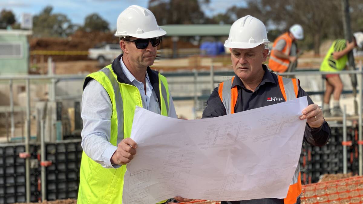 OVERVIEW: Leeton Shire Council's Josh Clyne (left) with SISP Riverina STEM project officer Ian Preston on site at the Leeton pool redevelopment project. Photo: Contributed 