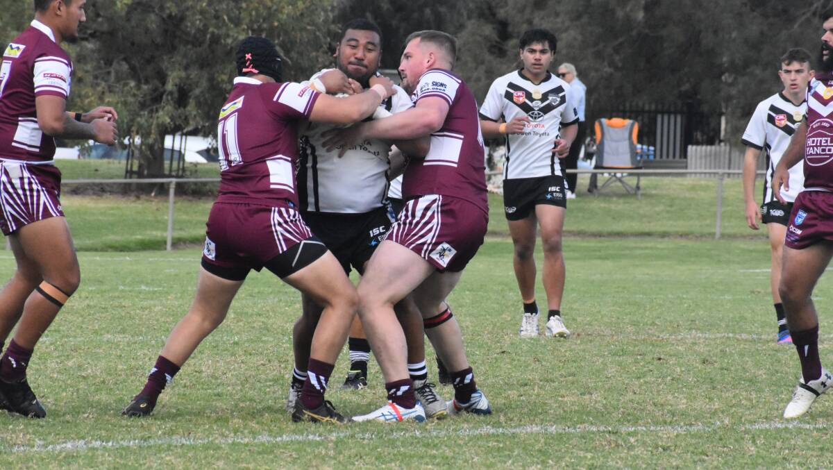 HARD WORK: The Yanco-Wamoon defence wraps up Black and Whites' Veti Mataa during an earlier match this season. Photo: Liam Warren