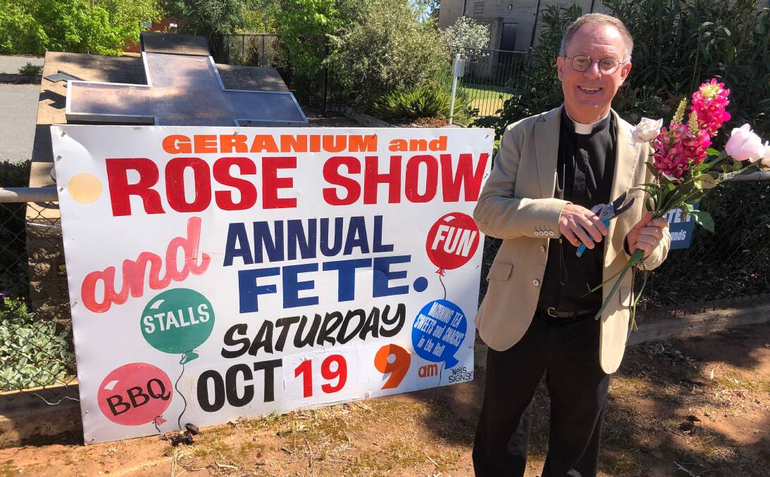 BLOOMING FUN: Father Robert prepares for the St Peter's fete and geranium and rose show. Photo: Talia Pattison