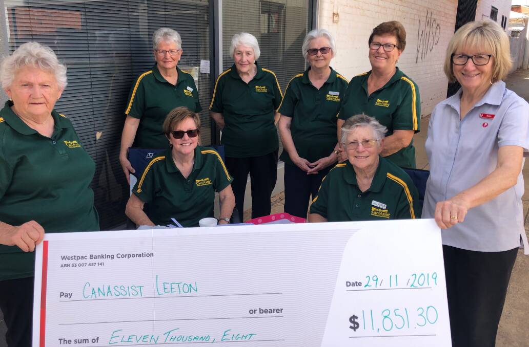 BIG DONATION: Lorraine Robertson (right) presents Leeton Can Assist members with the cheque for almost $12,000. Photo: Contributed
