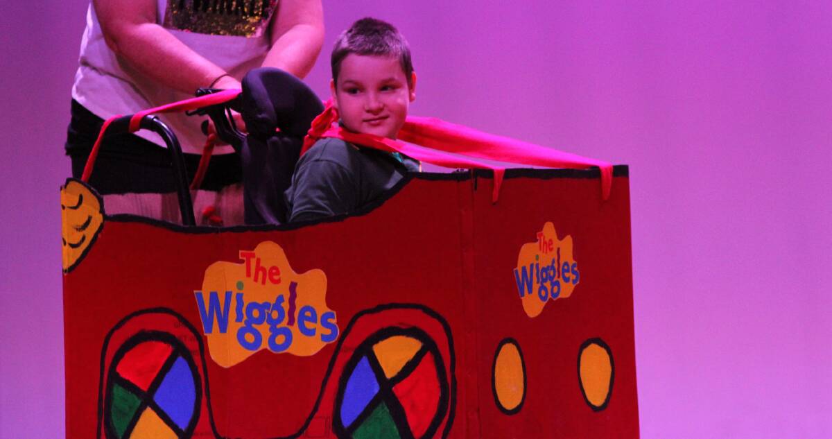 TOOT TOOT: Gralee School student Albert Dargan in his big red car during the concert event at the Roxy Theatre. Photo: Talia Pattison
