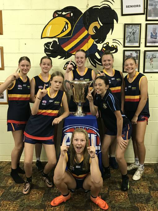 UP CLOSE: Leeton-Whitton's young crop of female footballers had an up close view of the AFL premiership cup during its visit to Leeton.