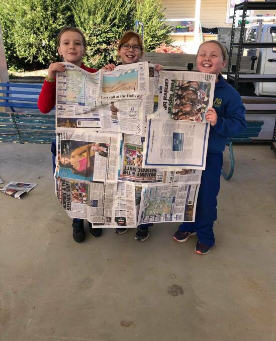 KNOWLEDGE: LPS students Jazzi Bales, Lola Maclean-Tuckett and Zara Lamont learn all about area using newspapers. 