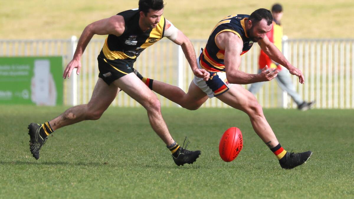 CHARGE: Leeton-Whitton's Bryce O'Garey attempts to pick up a loose ball during last week's close defeat at the hands of the Wagga Tigers. 