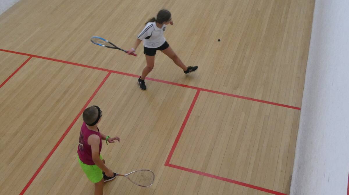 ON COURT: Isabel Thompson about to strike the ball with Alec Tait waiting to respond. Photo: Supplied